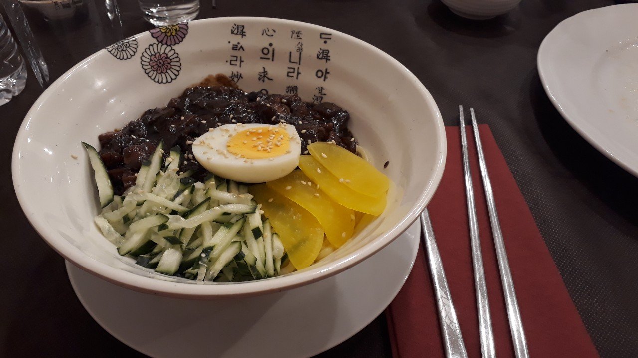 A bowl of jajangmyeon with black bean sauce and vegetable toppings