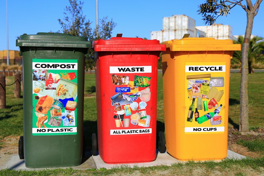 Three separate waste sorting bins in a public setting; the local accommodation’s labels and rules may differ.